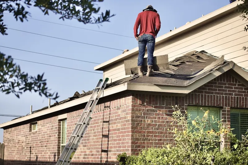 Professional roofer working on a residential roof in Sky View Manor